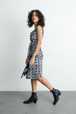 Model in 2 Party System print Duplo Dress, showcasing its side view, hand-dyed linen fabric and optional sash.
