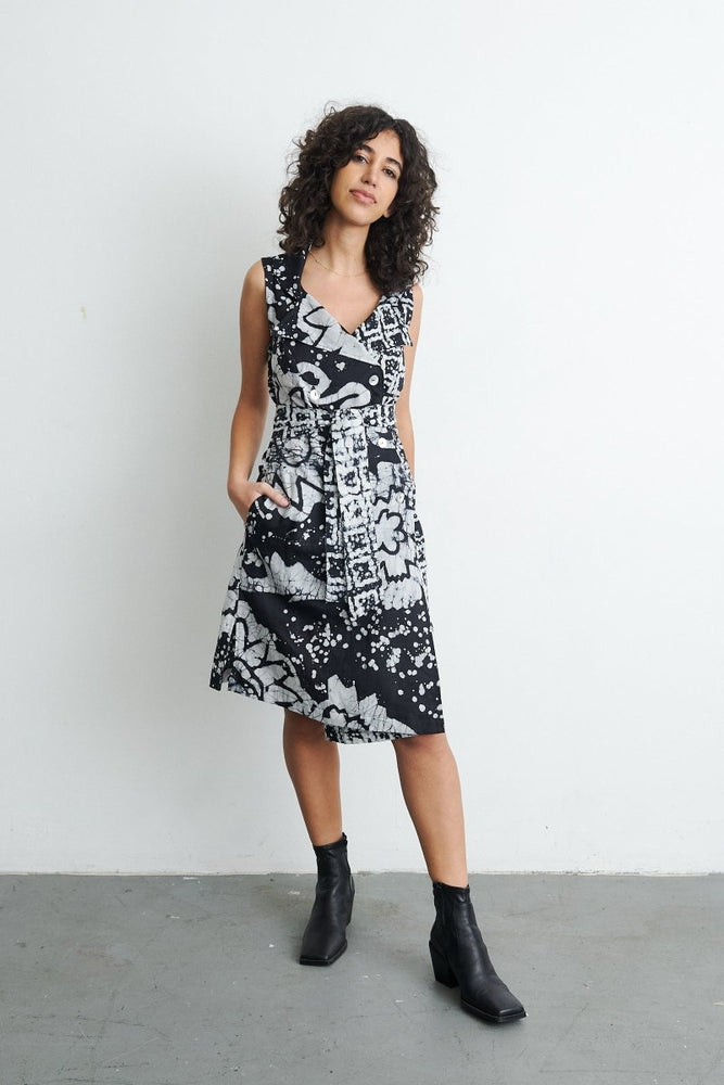 Sleeveless Duplo Dress in 2 Party System print, abstract black and white pattern, against a white wall.