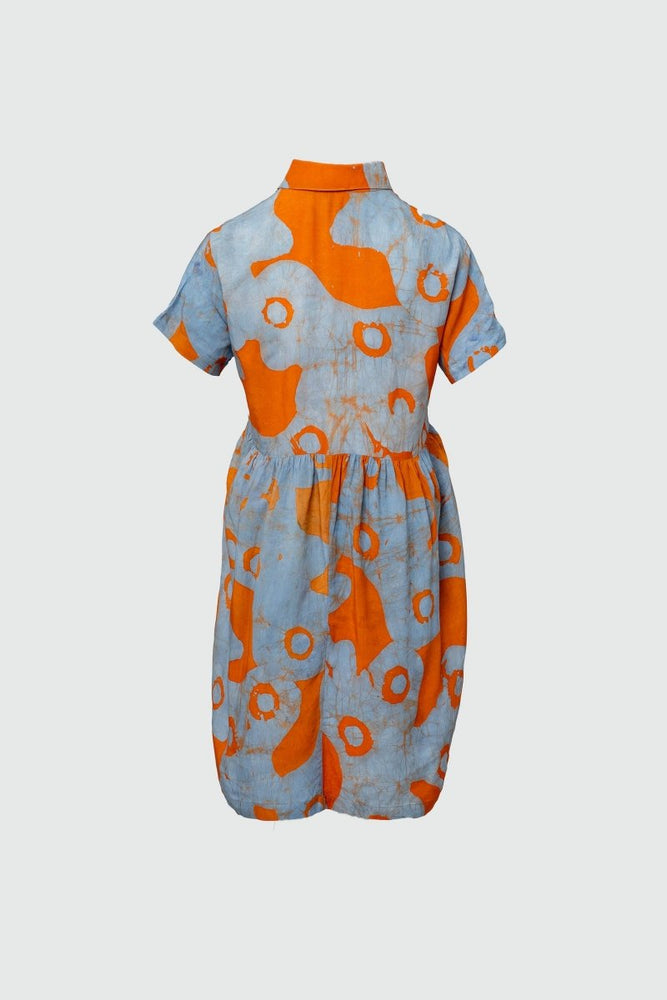 Back view of the Helia Dress in All Ideas print, high neckline, short sleeves, large orange circles on pale blue.