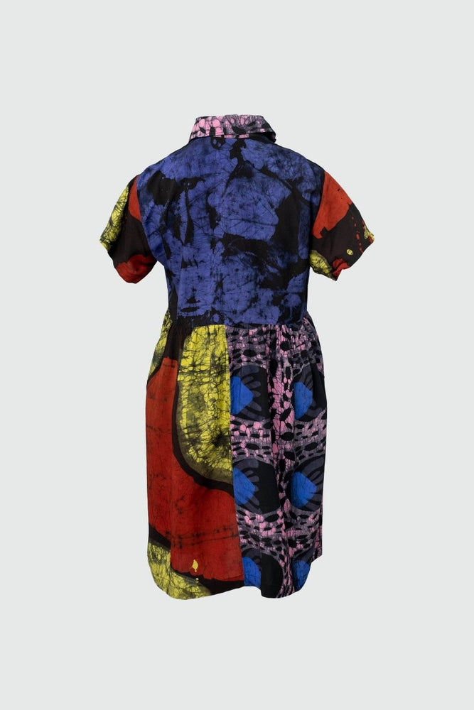 Eclectic Helia Dress in Hocus Pocus print, featuring a cinched waist and a patchwork of vibrant colors and patterns.