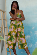 Mafalda Jumpsuit, Waters print, pink forms, yellow squiggles, white lines on green, wide legs, button placket, made in Ghana.