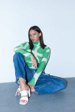 Relaxed Osei-Duro Stricta Turtleneck in Mangrove print, paired with denim jeans and white sandals, model sits casually.