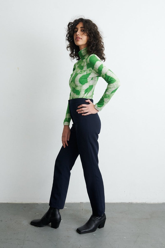 Osei-Duro Stricta Turtleneck in Mangrove print, featuring a high-neck design and paired with dark pants, exuding elegance.