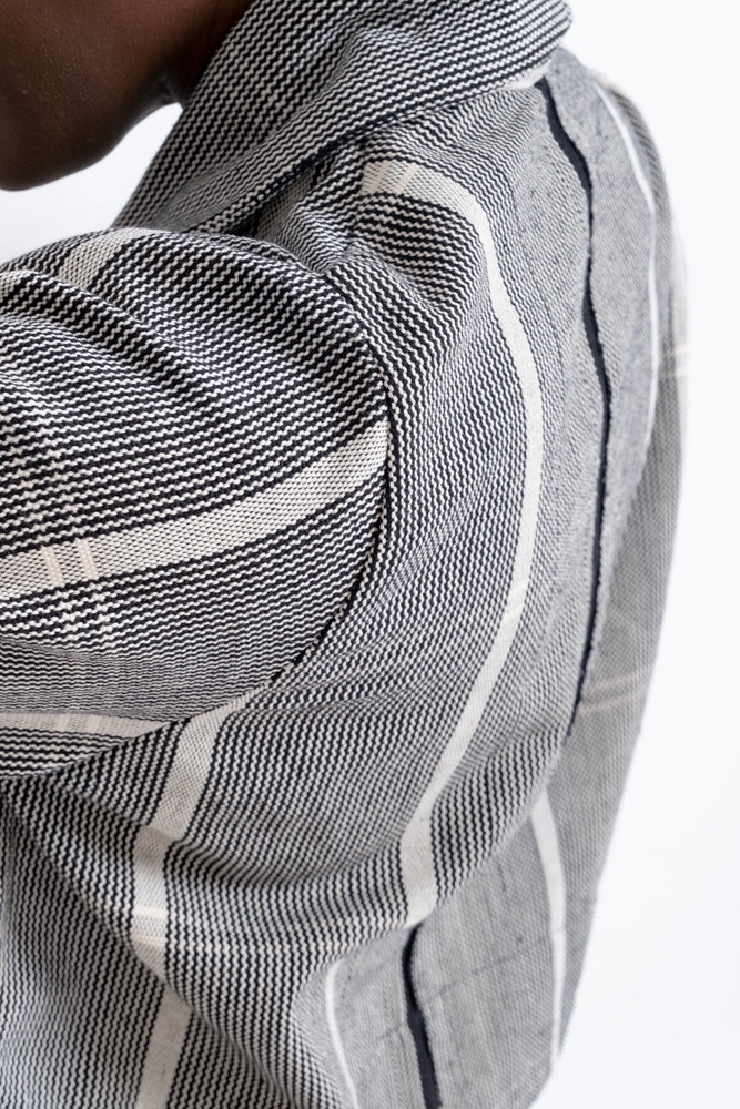 Close up of the handwoven 100% strip-woven black and white cotton on the Abiba Jacket.