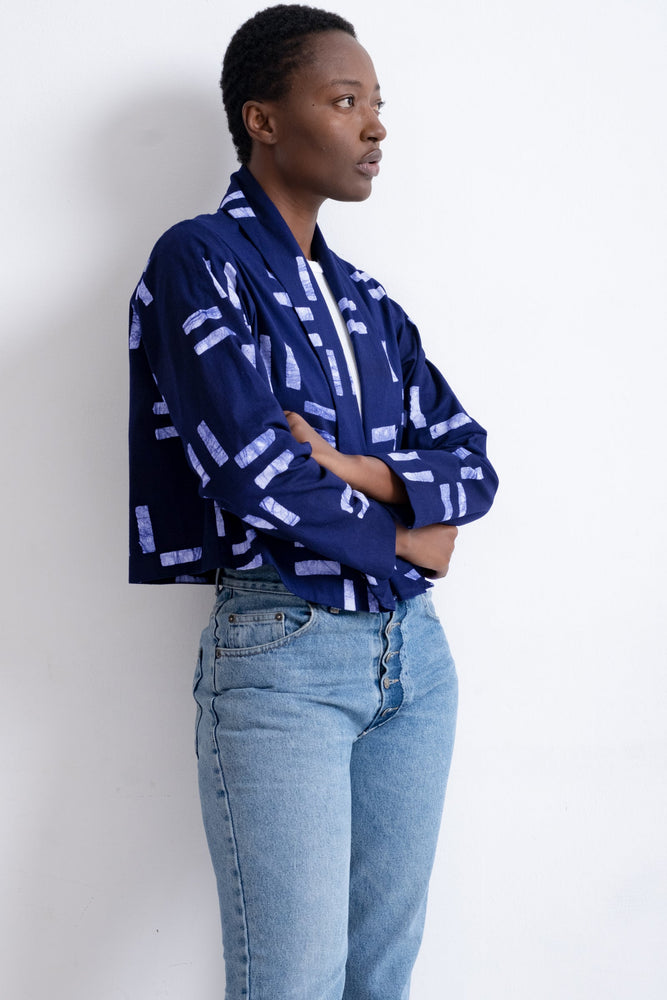 Abiba Jacket in blue with white abstract pattern, paired with light jeans, embodying a relaxed yet chic style.