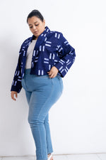 Woman in trendy Abiba Jacket with Middle Path design and light blue jeans against a white background.