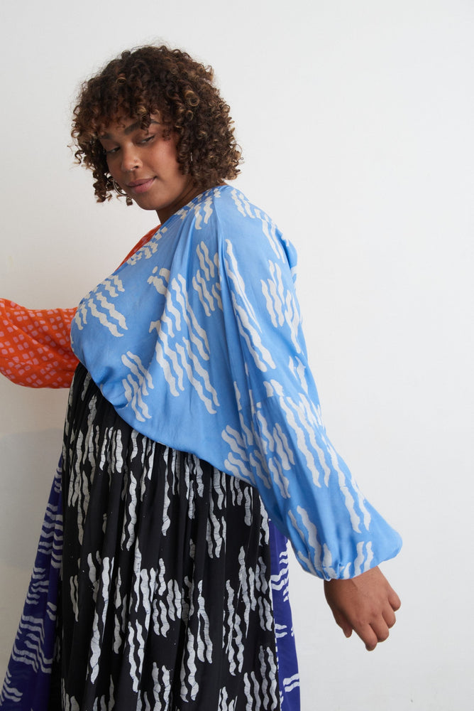 Flowy Bating Dress with vibrant Directions print, featuring batwing sleeves and a flattering v-neckline.