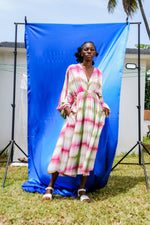 Serene Dreams Bata Dress with pink-green tie-dye, styled against a blue outdoor backdrop.