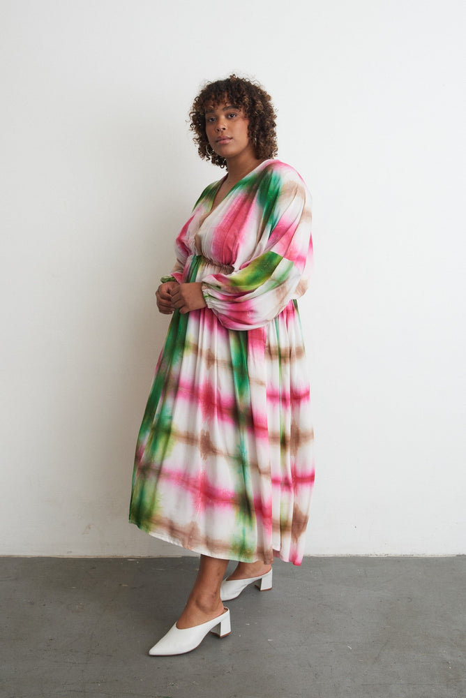 Serene Dreams Bata Dress with tie-dye pattern, long sleeves, and white heels for an airy, elegant look.