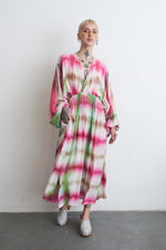 Serene Dreams Bata Dress in natural light, showcasing the long, flowing tie-dye design and white clogs.