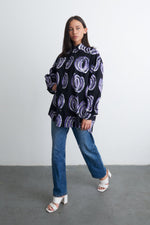 Stylish Bula Shirt with Good Signal print, paired with classic jeans and white heeled sandals for a smart look.