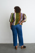 Colorful Flos Blouse in Speedboat print, paired with jeans and black studded clogs, against a white backdrop.