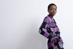 Elegant Accra Jumpsuit in Adepa print, purple and black patterns, long sleeves, against a minimalist white background.