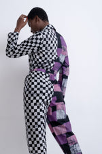 Chic Accra Jumpsuit in Adepa print, half checkered, half patchwork design, posed against a plain white background.