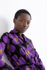 Accra Jumpsuit in Love Perfect print, long-sleeved shirt, vibrant purple floral pattern, against a white backdrop.
