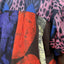 A guy in a vibrant shirt posing by a banana tree. His holiday shirt is all about hocus pocus!