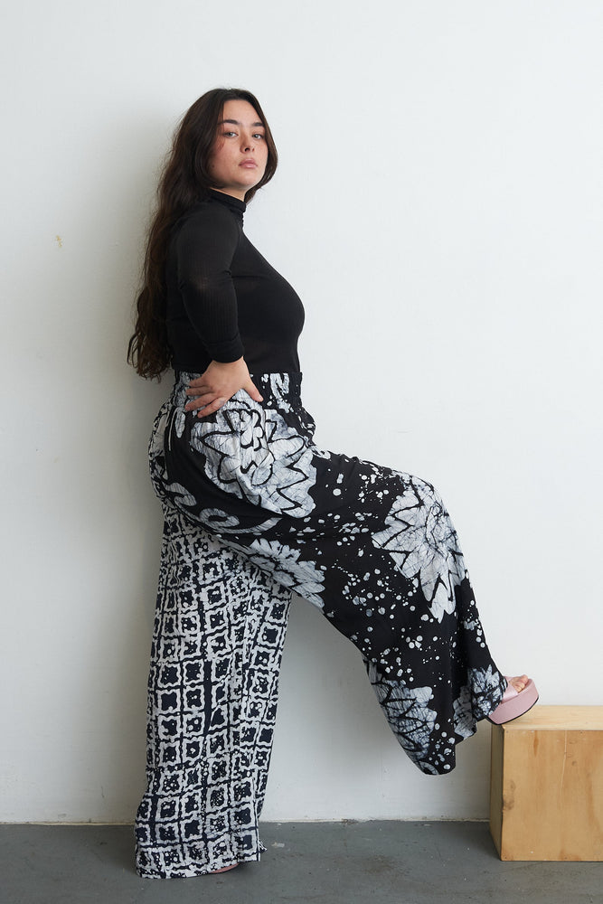 Latus Trousers in 2 Party System print, hand-dyed rayon with wide legs and elastic waist, crafted in Ghana.