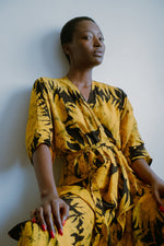 Elegant Letsa Dress in Aden print, highlighting the deep V-neckline and dramatic batwing sleeves.