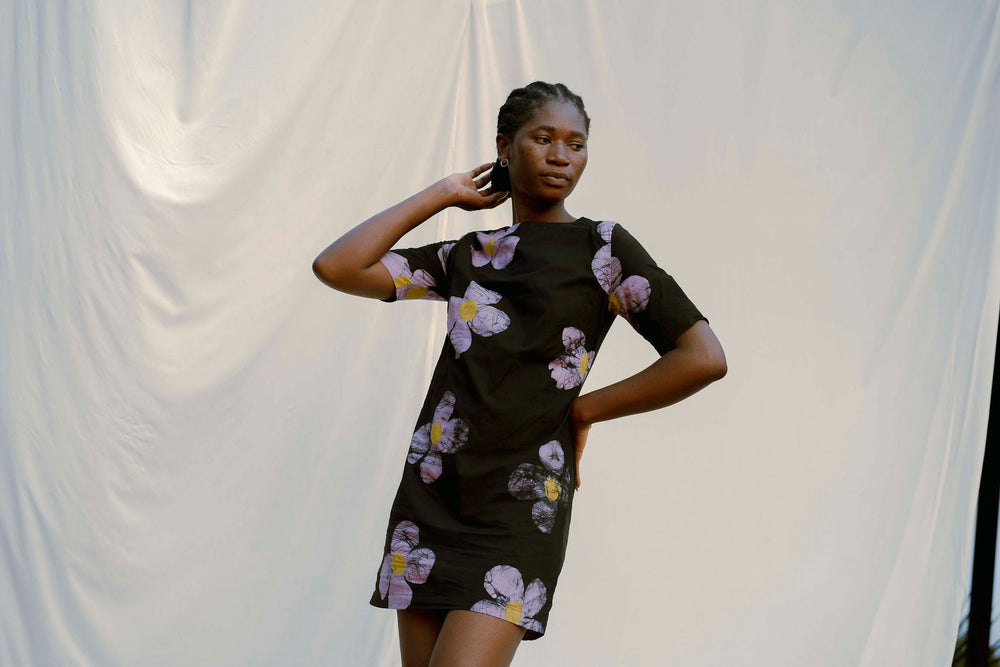 Muto Dress in Love Perfect, model against white backdrop, a '60s does 90’s style with floral patterns and crew neck.