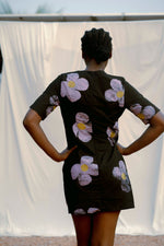 Muto Dress in Love Perfect, back view of dress, showcasing the purple floral pattern on black cotton fabric.