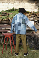 Back view of a man wearing the denim patchwork Nimes Jacket. Celebrate sustainable style.