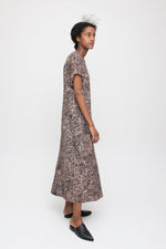 Chic Nonna Dress in Snakebite print, mid-length with short sleeves, paired with black pointed-toe shoes, white backdrop.
