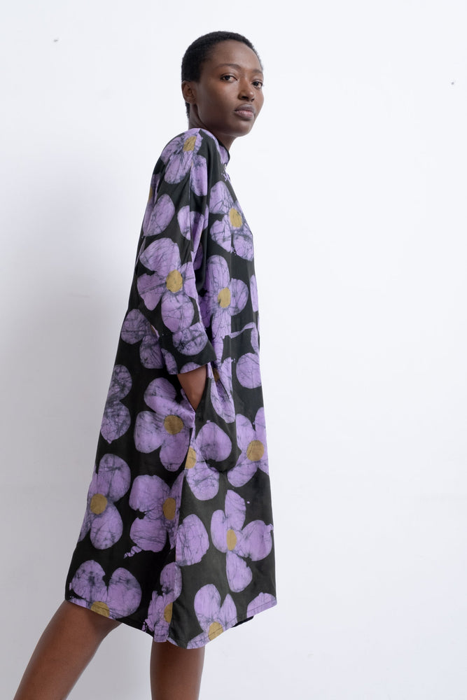 Side view of Para Dress with purple floral pattern, against a white background.