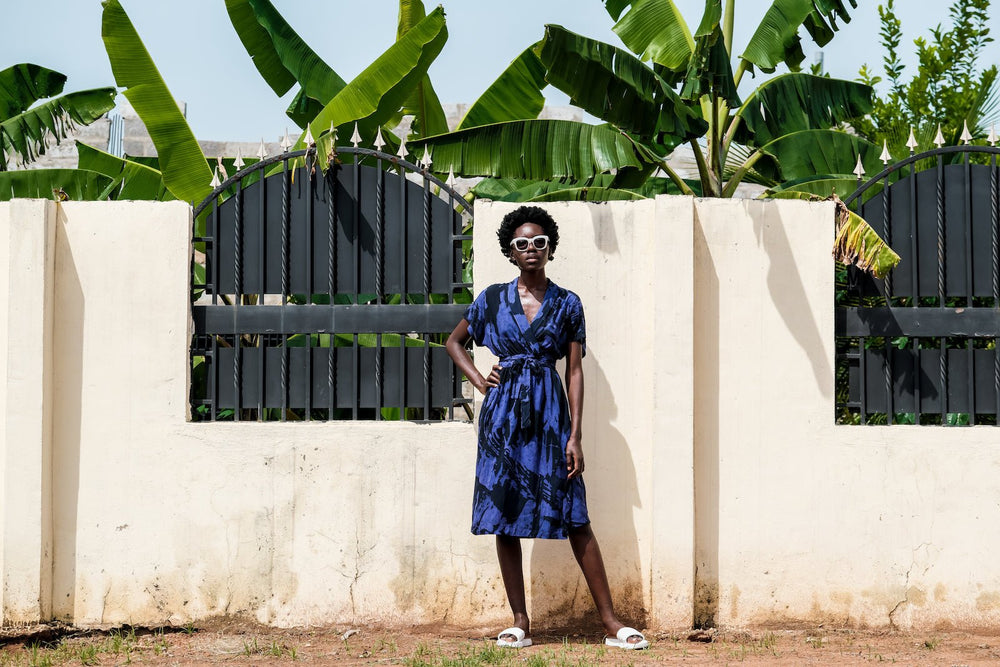 Elegant Sampa Dress with Rorschach print, wrap front, and inseam pockets, showcased in a natural outdoor setting.”