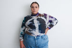 Stylish Osei-Duro tie-dye sweatshirt in blue and purple, paired with high-waisted jeans, against a white background.