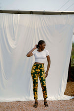 Model in Vitta Trousers stands against white backdrop outdoors, hand on hip, showcasing the vibrant Brain Wave design.
