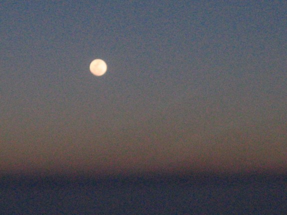 full moon over the Sahara, flying in.