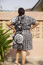 Back view of oversized cotton dress in 2X size with a black and white abstract flower and grid batik pattern.
