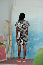Focus on an oversized cotton dress in a black and white batik pattern back tie, allowing for adjustable fit and style.