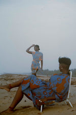 Relaxed beach moment with two individuals in Bating Dress in All Ideas print, enjoying the overcast seaside ambiance.