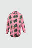 Long-sleeved Bula Shirt in Tunnel of Love batik print with bold green and black abstract shapes on pink, button-up front.