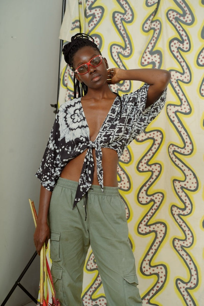 Epo Tie Top in 2 Party System print, loose fit, adjustable front tie, styled with olive trousers, black & white design.