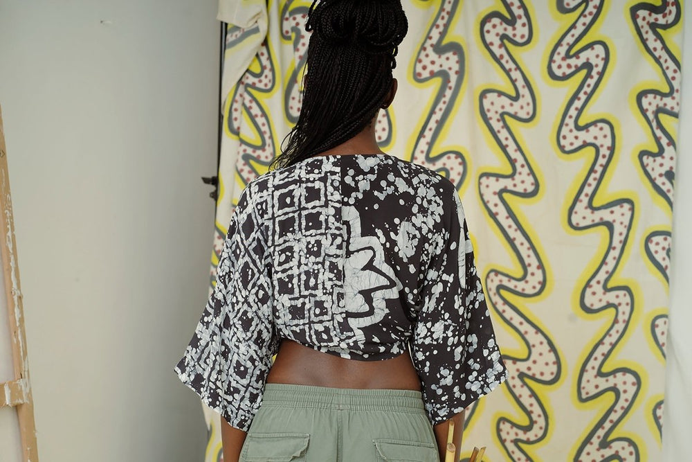 Epo Tie Top in 2 Party System print, black & white pattern, loose sleeves, light green bottoms, yellow & black background.