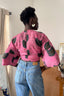 Back view of Epo Tie Top in playful Tunnel of Love print, paired with blue jeans for a chic, casual look.