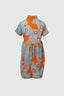 Back view of the Helia Dress in All Ideas print, high neckline, short sleeves, large orange circles on pale blue.