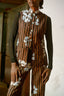 Person in Index Vest with Ruga print, showcasing the brown and black stripes with flowers scattered print.