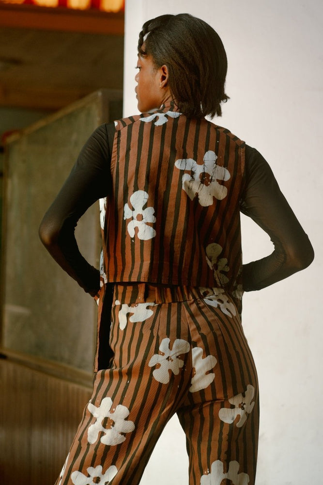 Back view of person in Index Vest with Ruga print, showcasing the unique print and design in warm indoor lighting.