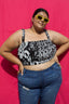 Lupi Top in 2 Party System print, plus-size model against pink backdrop, showcasing bold black and white pattern.