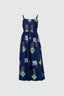 Elegant Mafalda Jumpsuit, Location print, culotte legs, geometric green/white shapes, dark blue backdrop, buttoned bodice.