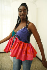 Pastiche Valley’s sleeveless top with flared waist, in a multicolored design, embodies a free-spirited, artistic vibe.