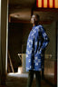 Model wearing the Press Dress with white print, standing in a sunlit room with shadows on the floor.