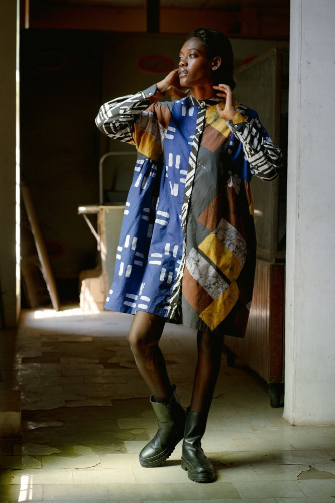 Oversized Press Dress in Virtual Reality batik print with mandarin collar, long sleeves, and side gathers, styled with black boots.