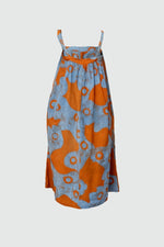Sleeveless Saya Dress with blue and orange print, lightweight fabric, gathered waist, on a simple background.