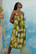 Front view of the Saya Dress in Waters print, showcasing the pink organic forms, yellow squiggles on a dark green background.