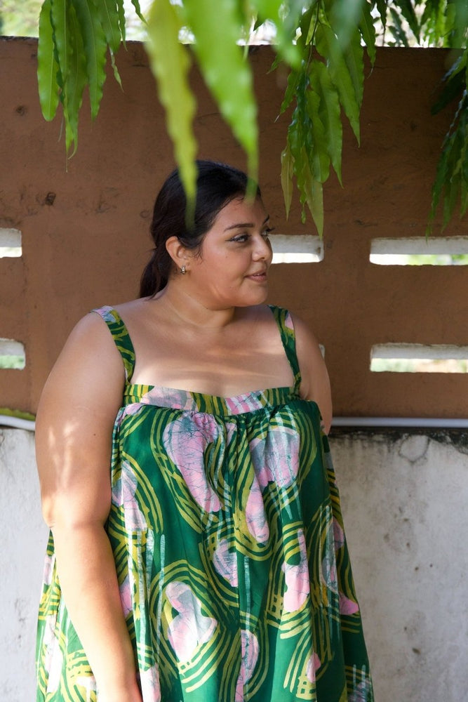 Person wearing the Saya Dress in Waters print, standing outdoors under a tree, showcasing the front detail of the dress.