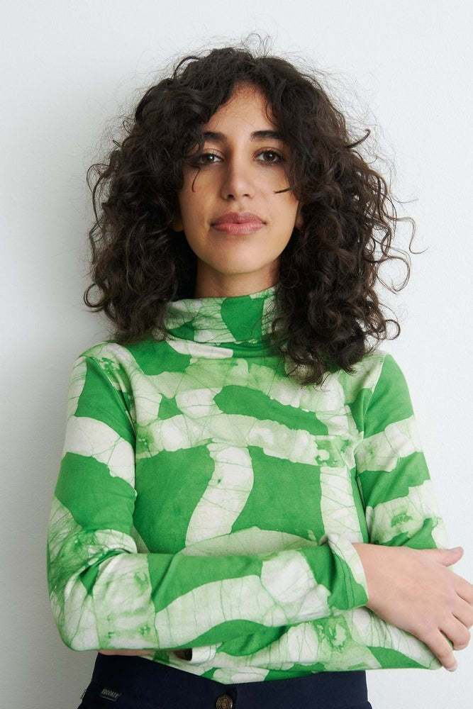 Fitted Osei-Duro Stricta Turtleneck in Mangrove print, showcasing the unique hand batiked design on stretchy cotton fabric.